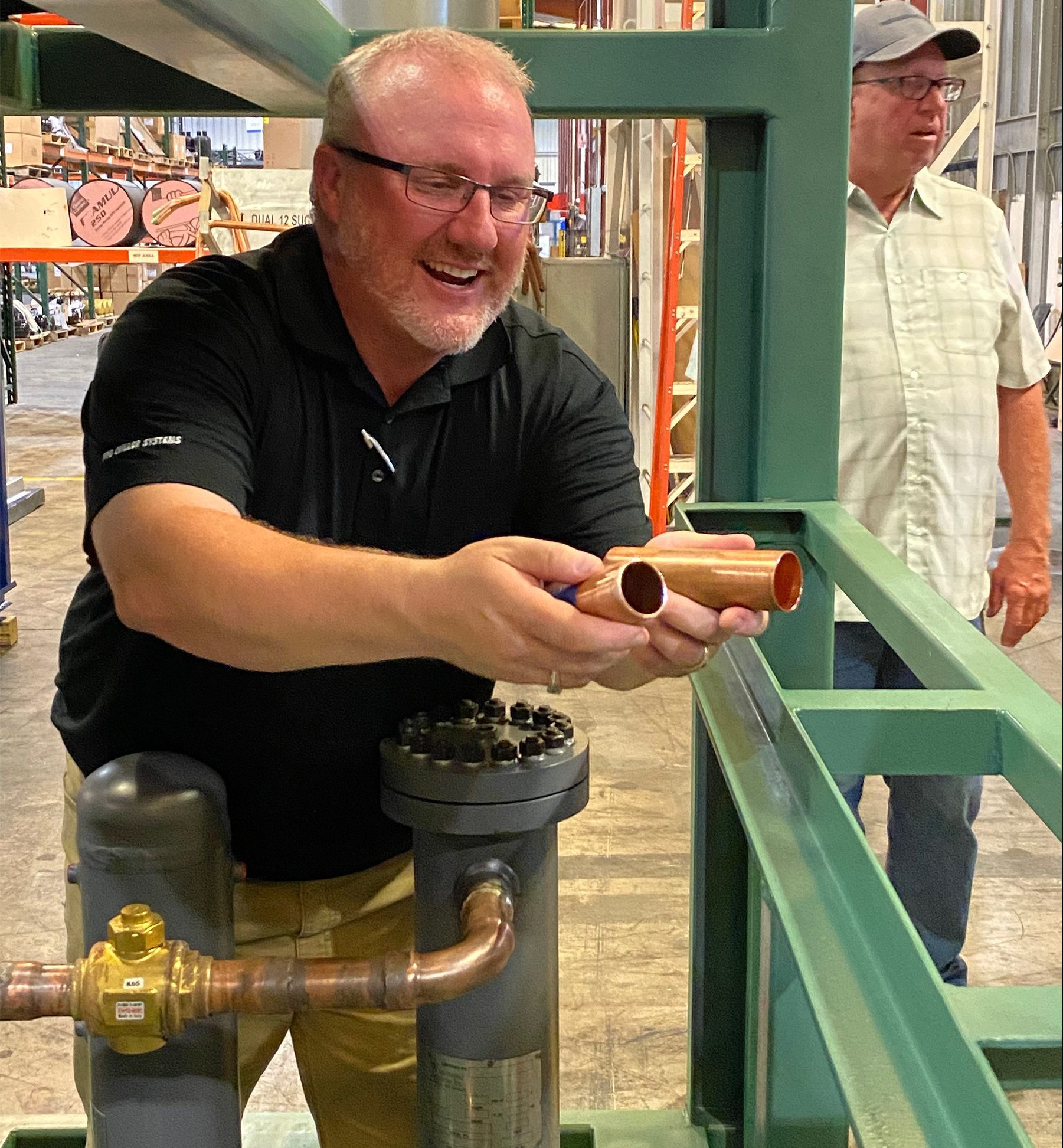 Damon Reed shows the thicker copper piping used on the CO2 system compared to a traditional freon-based system.